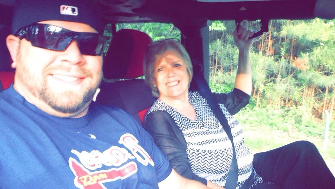 All smiles on a sunny car ride, Braves gear on.