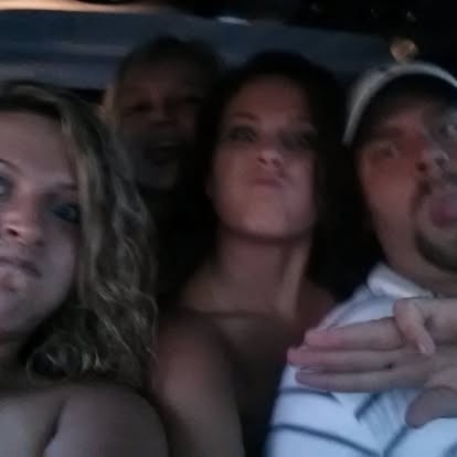 A carful of friends piled in, laughing and making faces.